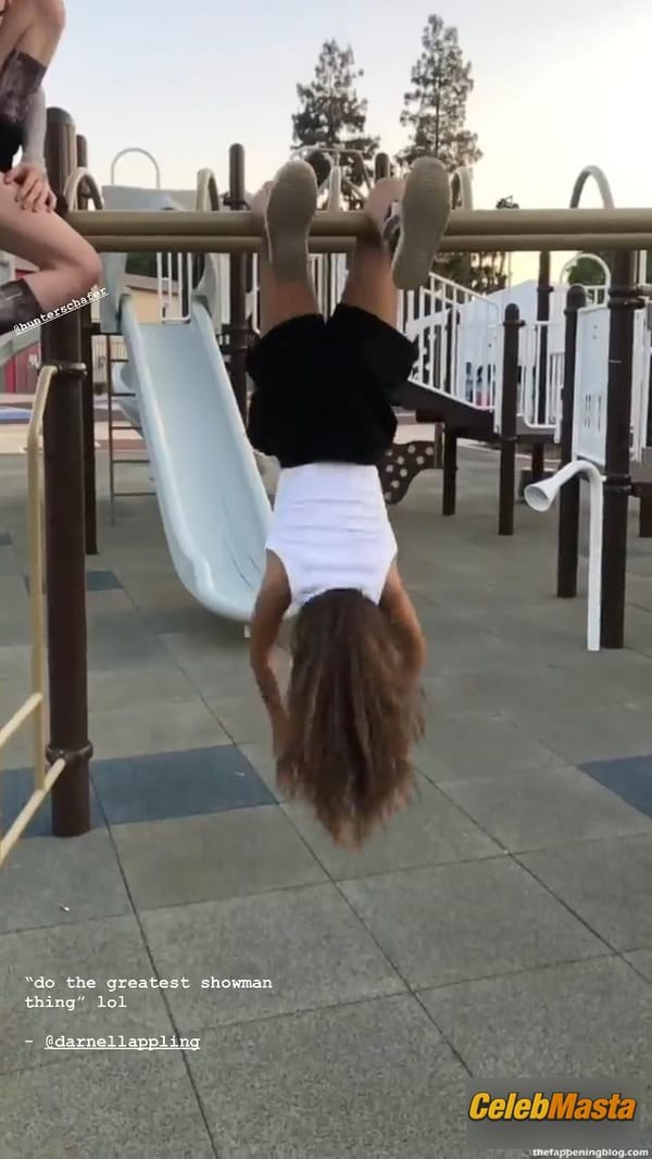 Zendaya poses on the playground in a white top without a bra and does a strange exercise photo 4
