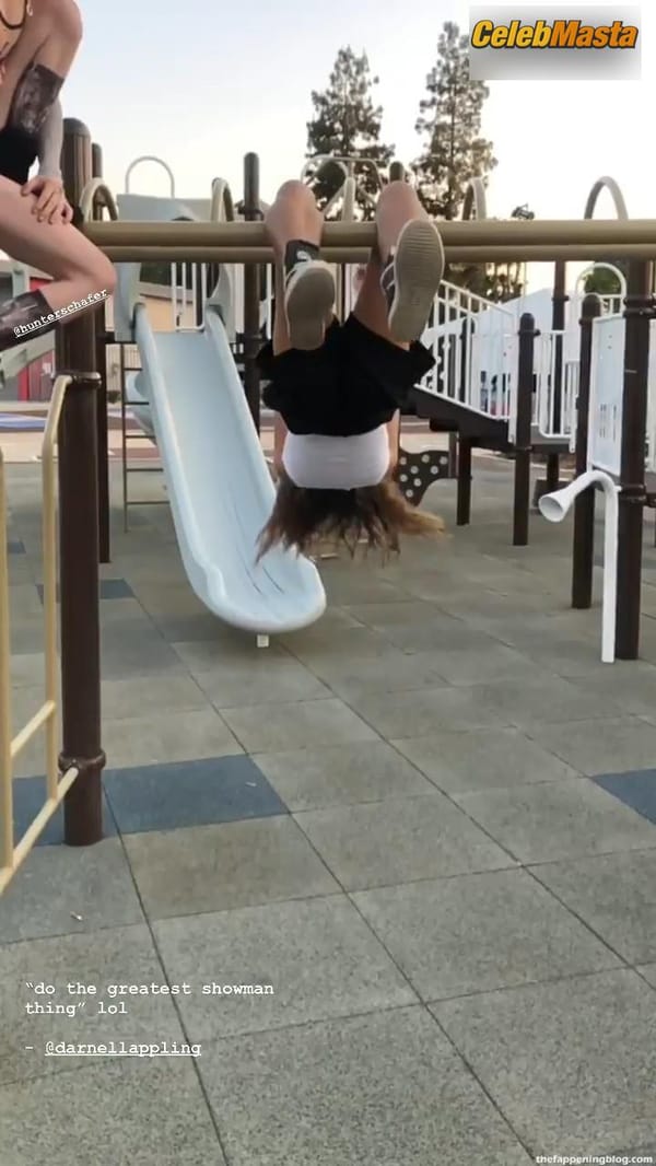 Zendaya poses on the playground in a white top without a bra and does a strange exercise photo 5