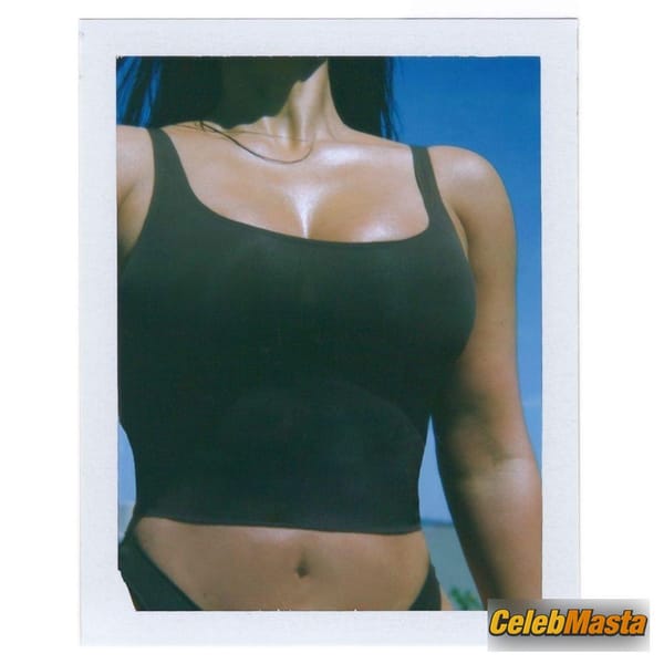 Kim Kardashian soaks up the sun on the beach while flashing her curves in new Skims photo 8