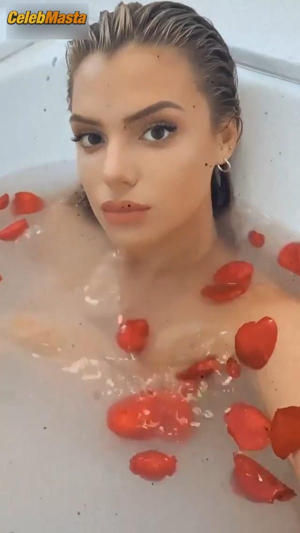 Alissa Violet in the bath with rose petals covering her breasts with her hands photo 5