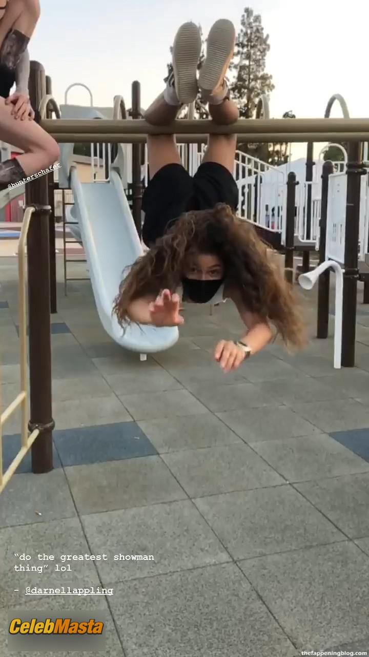 Zendaya poses on the playground in a white top without a bra and does a strange exercise Photo Gallery photo 2
