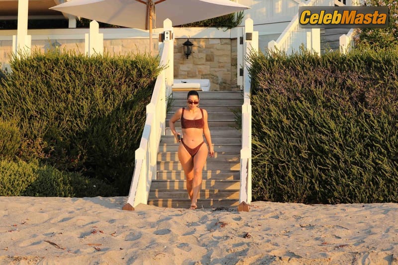 Kim Kardashian rises up early for a morning sunrise stroll in a maroon bikini showcasing her famous sexy curves in Malibu Photo Gallery photo 1