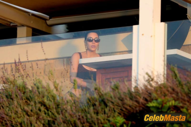 Kim Kardashian rises up early for a morning sunrise stroll in a maroon bikini showcasing her famous sexy curves in Malibu Photo Gallery photo 2